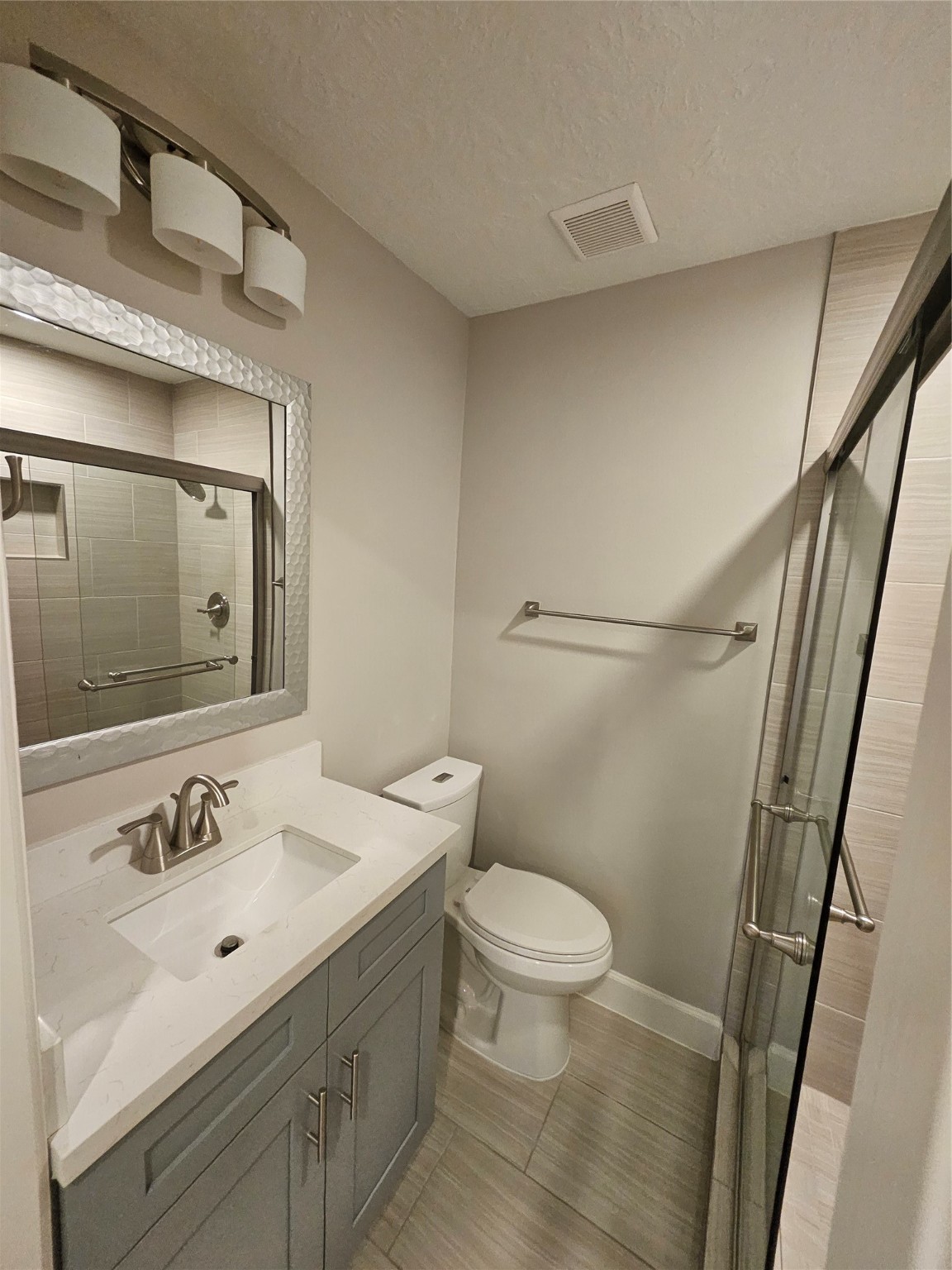 2101 Fountain View Drive, Unit 4 6 Houston, TX 77057 - Photo 13 of 26 a bathroom with a sink mirror vanity and toilet