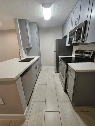 a kitchen with a sink and a refrigerator