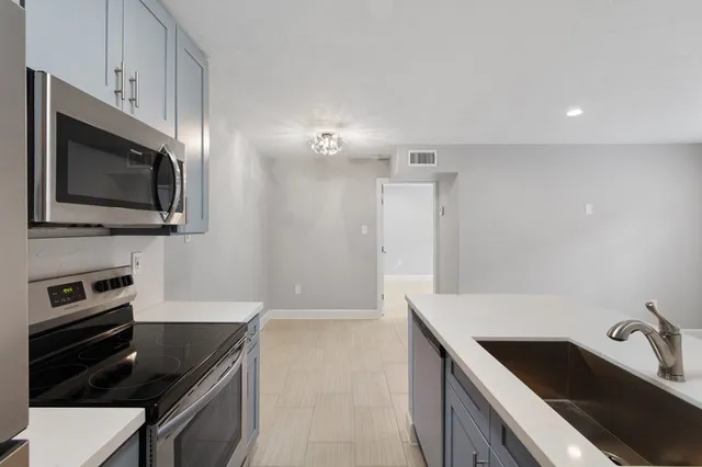a stove top oven sitting inside of a kitchen