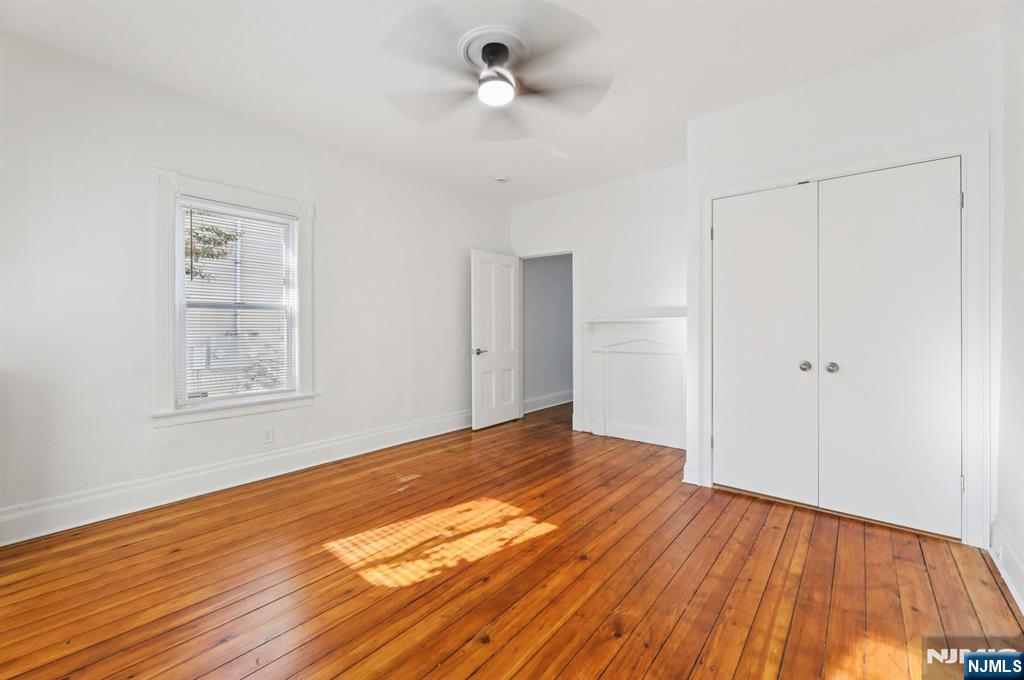 74 Forest Street, Unit 1 Montclair, NJ 07042 - Photo 11 of 23 a view of an empty room with wooden floor and a ceiling fan