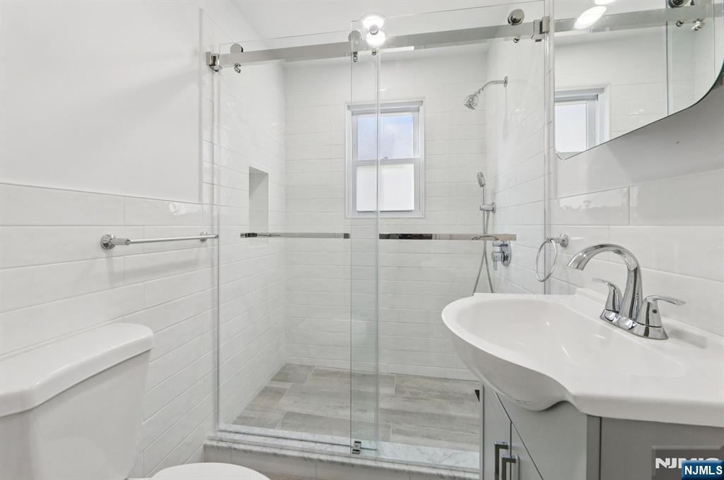 74 Forest Street, Unit 1 Montclair, NJ 07042 - Photo 12 of 23 a bathroom with a sink shower and a toilet