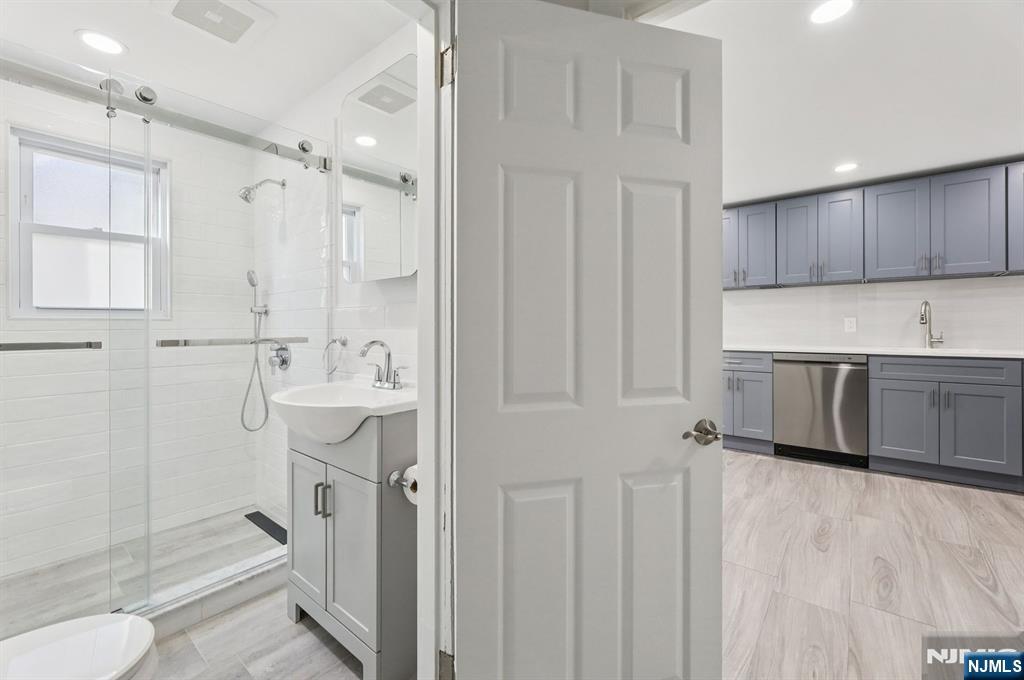 74 Forest Street, Unit 1 Montclair, NJ 07042 - Photo 13 of 23 a bathroom with a sink a toilet and shower
