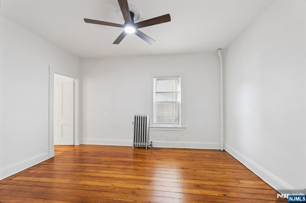 74 Forest Street, Unit 1 Montclair, NJ 07042 - Photo 7 of 23 a view of empty room with wooden floor and fan