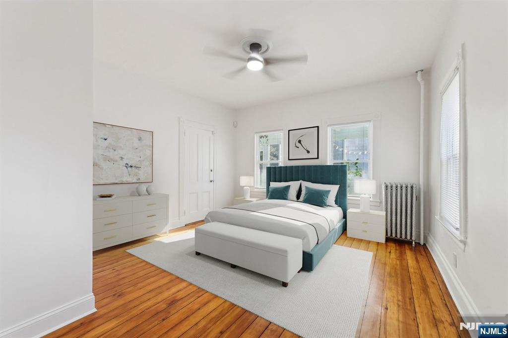 74 Forest Street, Unit 1 Montclair, NJ 07042 - Photo 9 of 23 a spacious bedroom with a bed and a chandelier