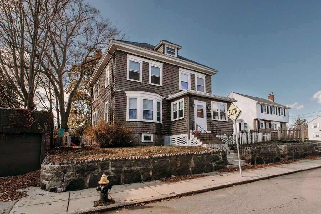 147 Train Street Boston, MA 02122 - Photo 1 of 27 a front view of a house with a yard