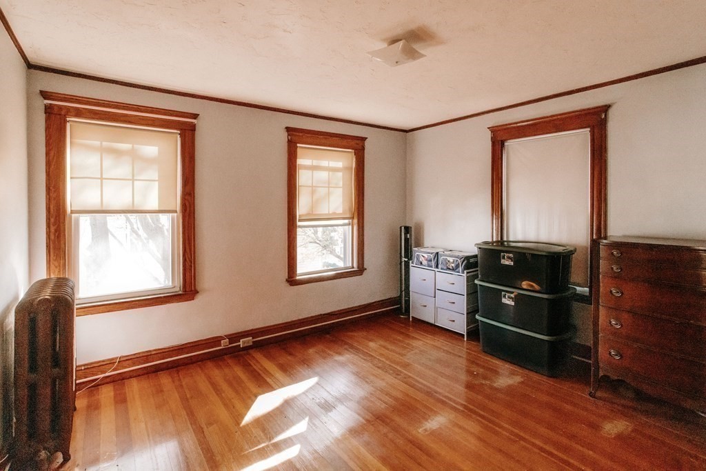 147 Train Street Boston, MA 02122 - Photo 11 of 27 a kitchen with granite countertop a refrigerator cabinets and wooden floor