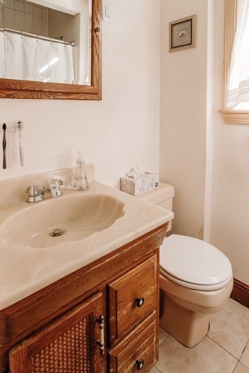 147 Train Street Boston, MA 02122 - Photo 12 of 27 a bathroom with a sink and a toilet