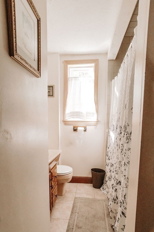 147 Train Street Boston, MA 02122 - Photo 13 of 27 a bathroom with a toilet and a mirror