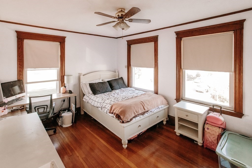 147 Train Street Boston, MA 02122 - Photo 17 of 27 a bedroom with a bed and wooden floor