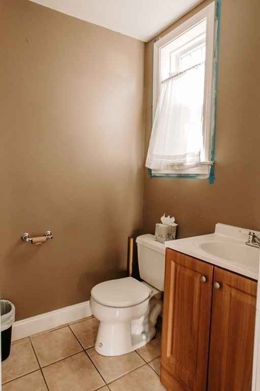147 Train Street Boston, MA 02122 - Photo 25 of 27 a bathroom with a toilet a sink and a window