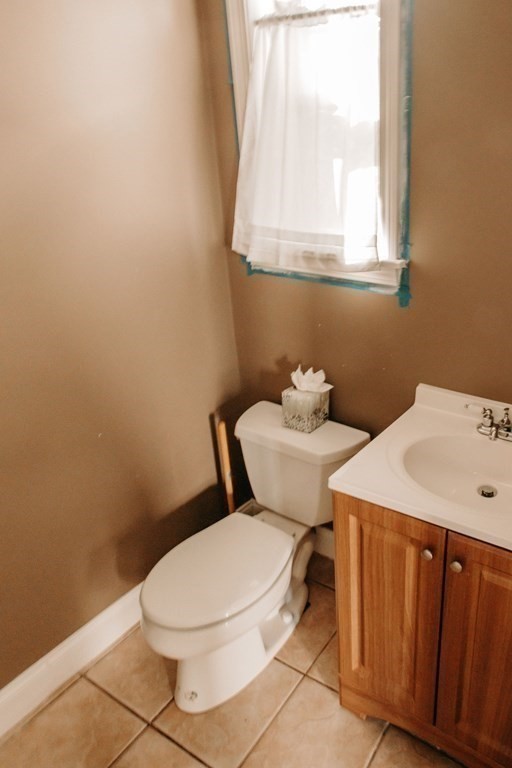 147 Train Street Boston, MA 02122 - Photo 26 of 27 a white toilet sitting next to a bathroom sink
