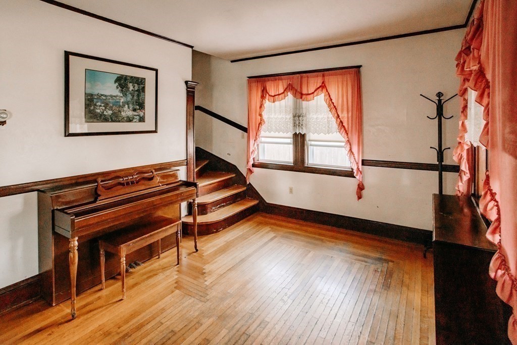 147 Train Street Boston, MA 02122 - Photo 6 of 27 a living room with wooden floor and a table