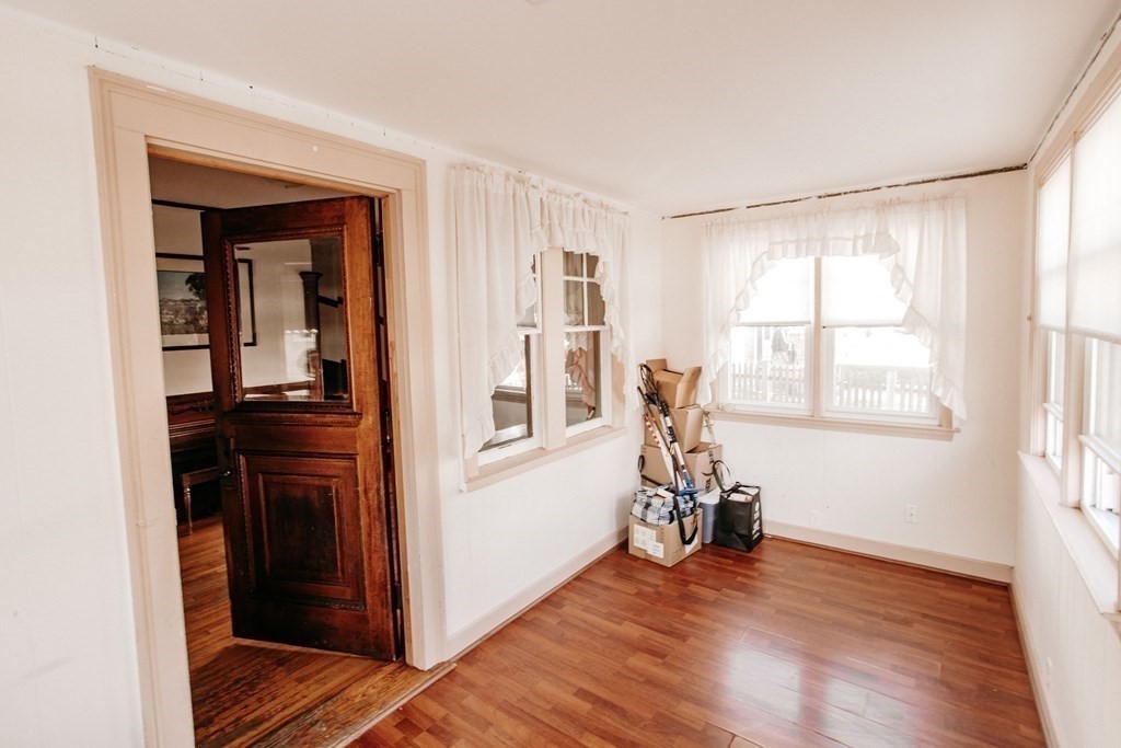 147 Train Street Boston, MA 02122 - Photo 7 of 27 a view of a livingroom with wooden floor and a bathroom