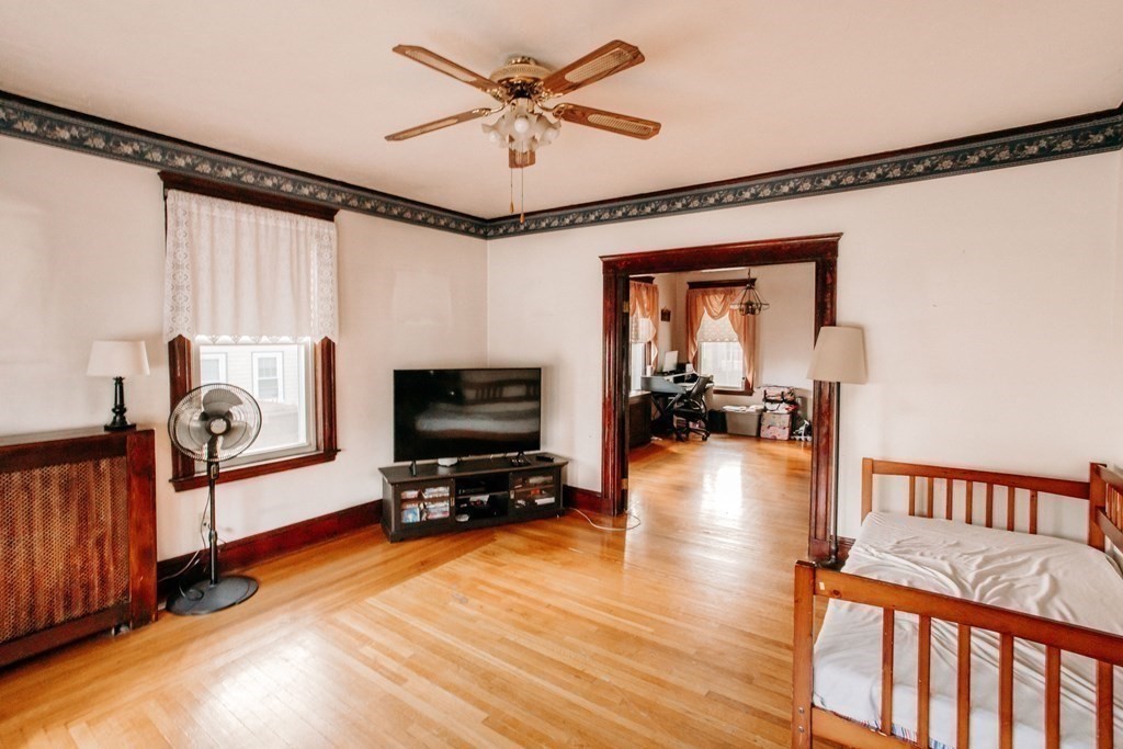 147 Train Street Boston, MA 02122 - Photo 9 of 27 a view of a livingroom with furniture hardwood floor and a ceiling fan