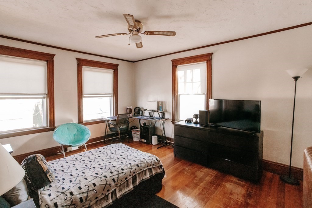 147 Train Street Boston, MA 02122 - Photo 10 of 27 a bedroom with a bed and a flat screen tv