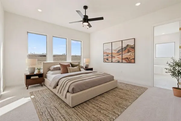 a bedroom with a large bed and a chandelier
