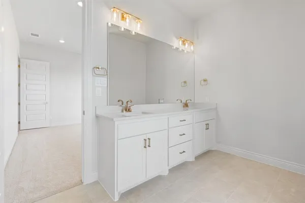 a bathroom with a double vanity sink and mirror