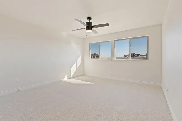 a view of a livingroom with a ceiling fan and window