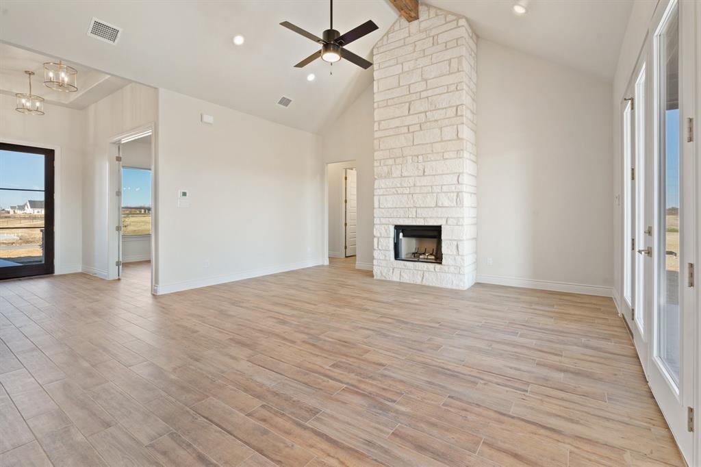 412 Collum View Azle, TX 76020 - Photo 6 of 29 an empty room with wooden floor fireplace and windows