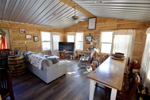 a living room with furniture fireplace and a large window