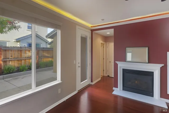 a kitchen with stainless steel appliances a sink a stove a refrigerator cabinets and a window