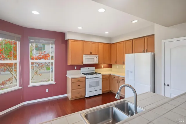 a spacious bathroom with a granite countertop sink and a mirror