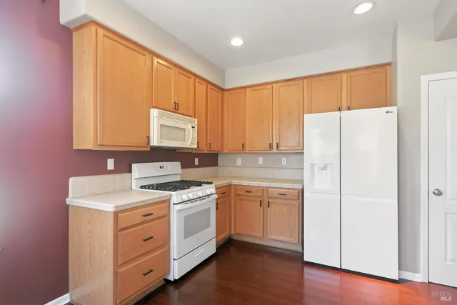 a view of a hallway with wooden floor and windows