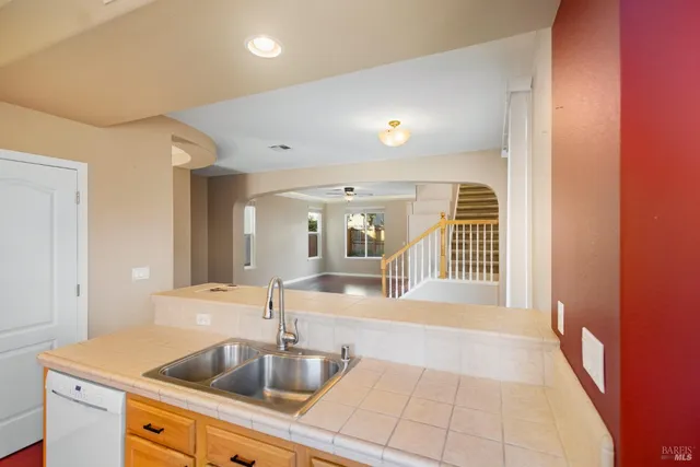 a view of a hallway to a livingroom with furniture