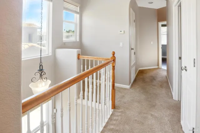 a view of a room with wooden floor and a window