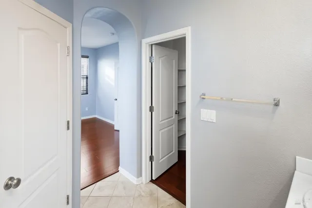 an empty room and a chandelier fan