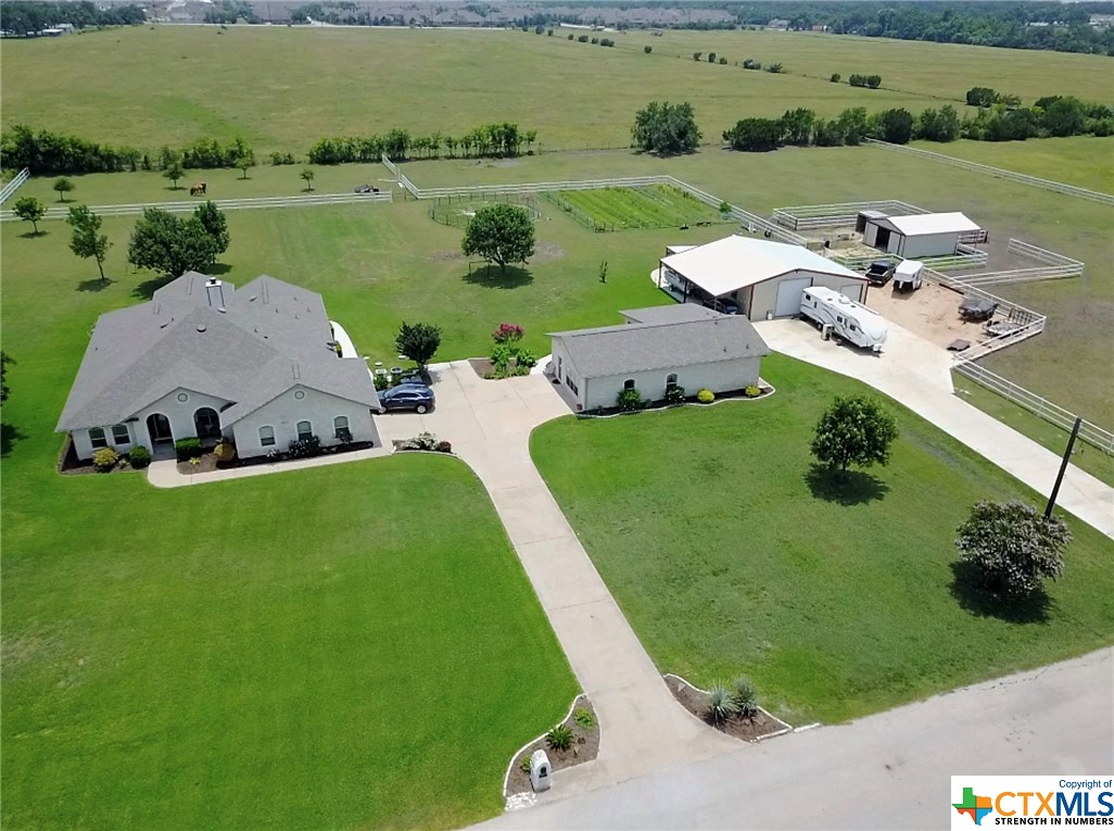 an aerial view of a house with outdoor space