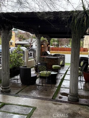 a view of a porch with furniture and a yard