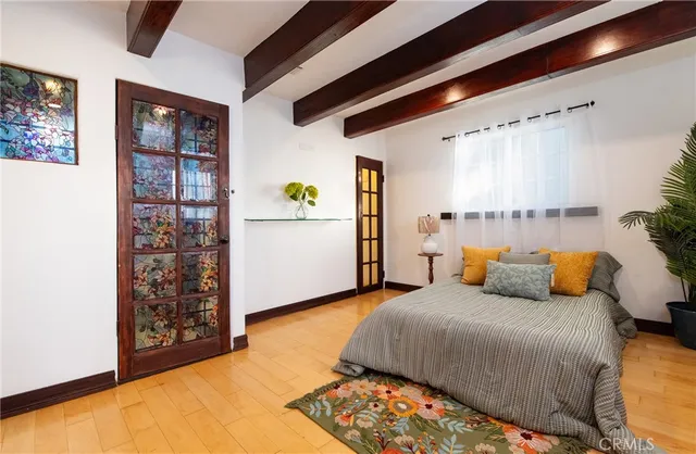 a bedroom with a bed and a window