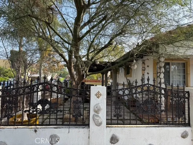 front view of a house with large trees