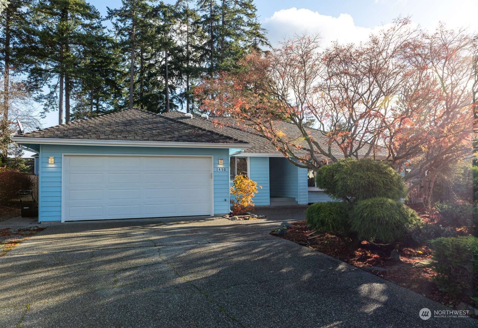 1450 Southwest Islander Lane Oak Harbor, WA 98277 - Photo 2 of 40 a front view of house with yard and trees around