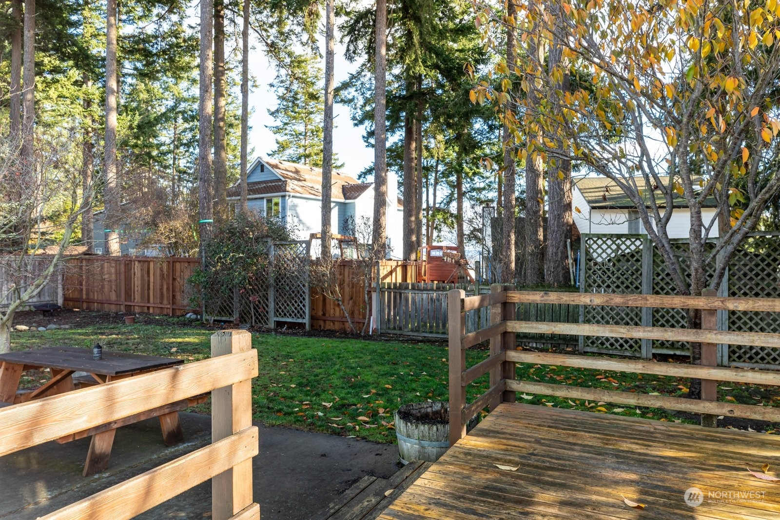 1450 Southwest Islander Lane Oak Harbor, WA 98277 - Photo 34 of 40 a view of backyard with wooden fence and large trees