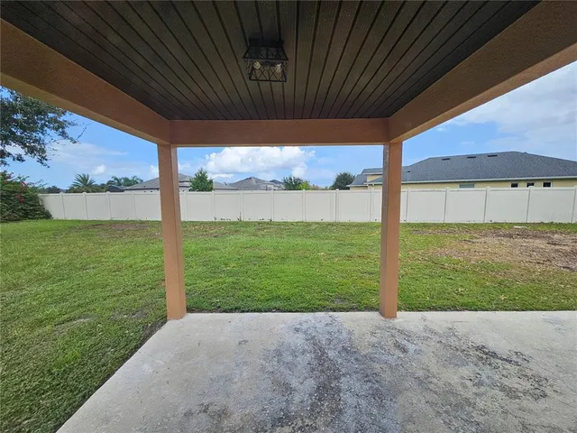 a view of a backyard with wooden floor and roof