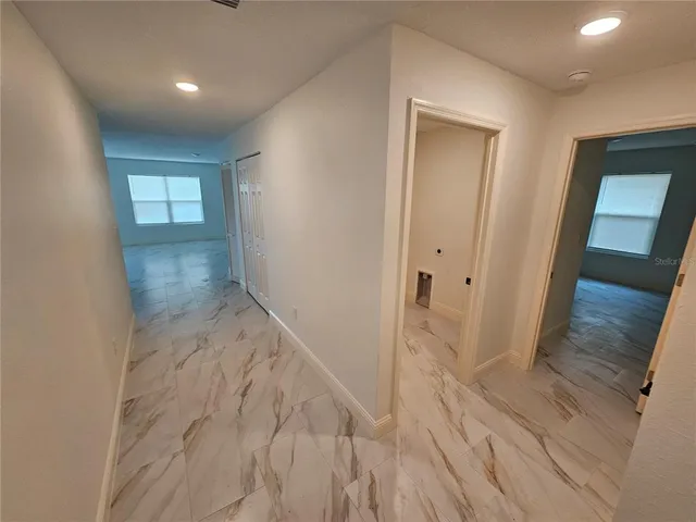 a view of hallway with wooden floor