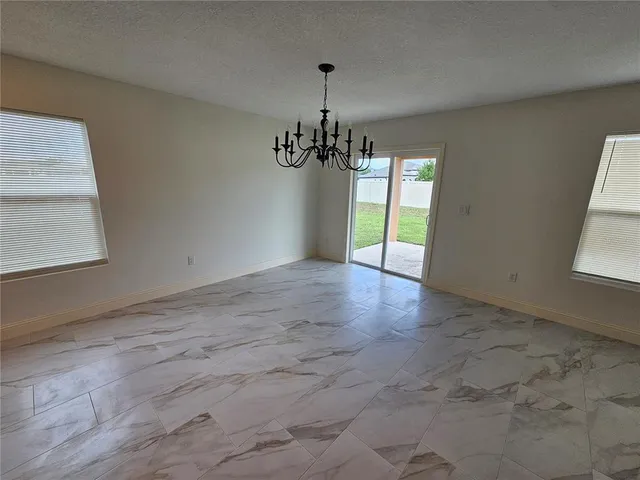 a view of a room with window and chandelier