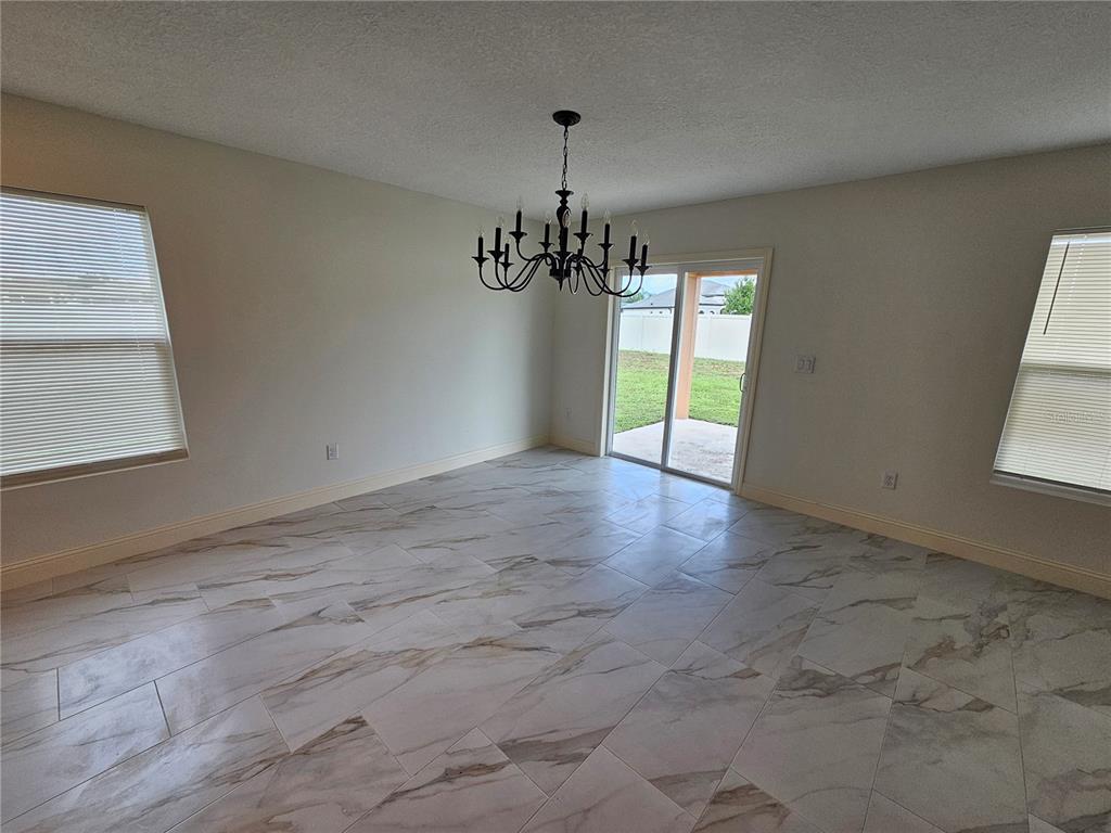 1640 Strathmore Circle Mount Dora, FL 32757 - Photo 4 of 18 a view of a room with window and chandelier