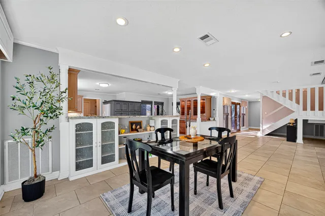 a view of a dining room with furniture and a potted plant