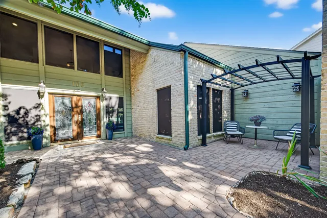 a view of a house with backyard porch and sitting area