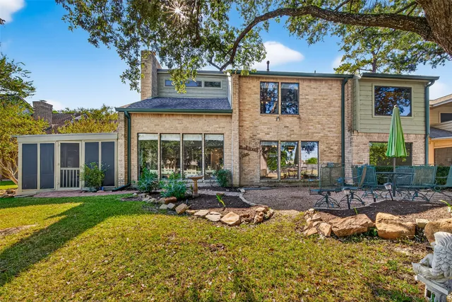 a view of a house with backyard porch and sitting area