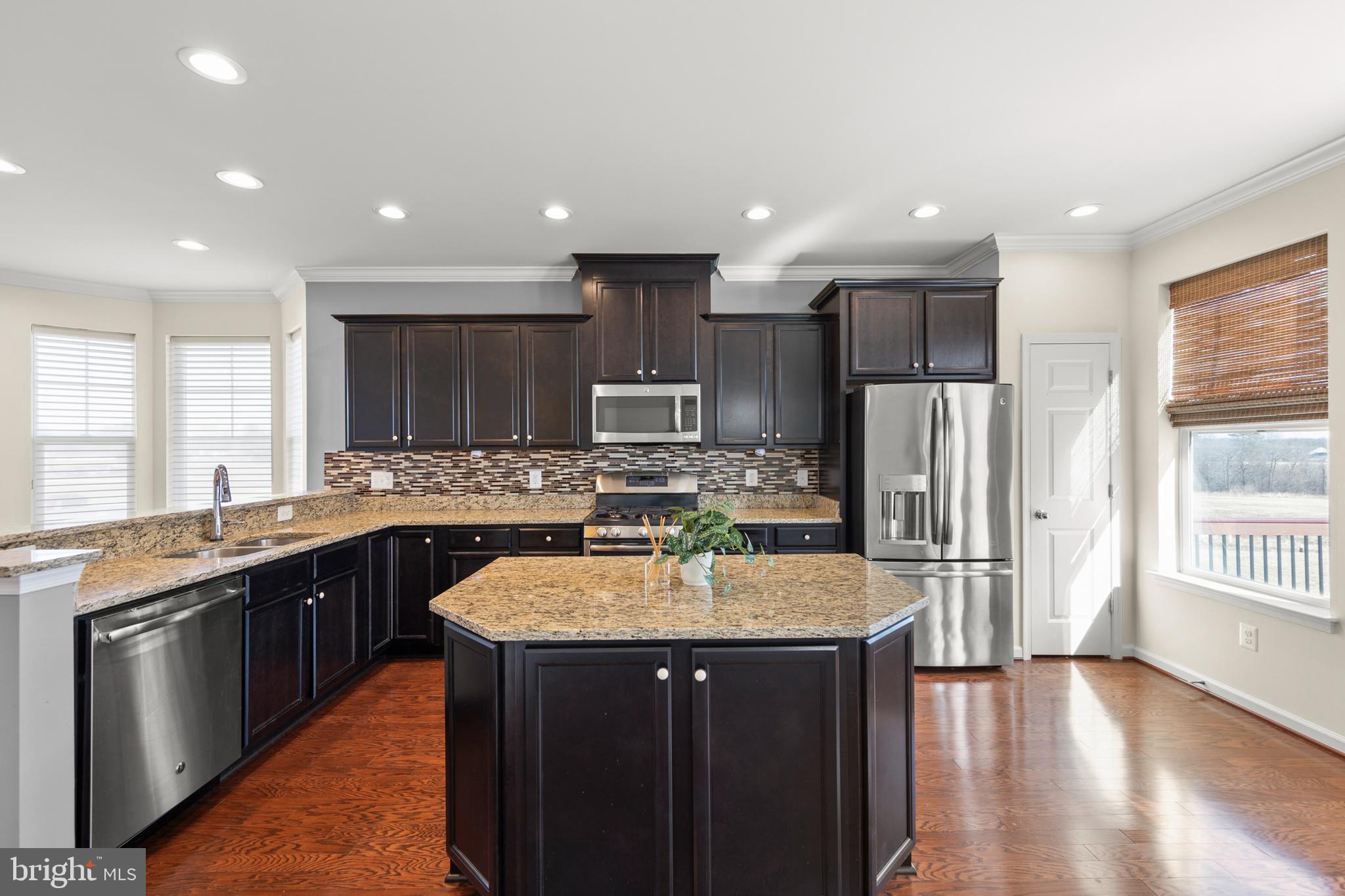 210 Flyfoot Drive Stephenson, VA 22656 - Photo 16 of 38 a kitchen with stainless steel appliances granite countertop a sink a stove a refrigerator and a oven