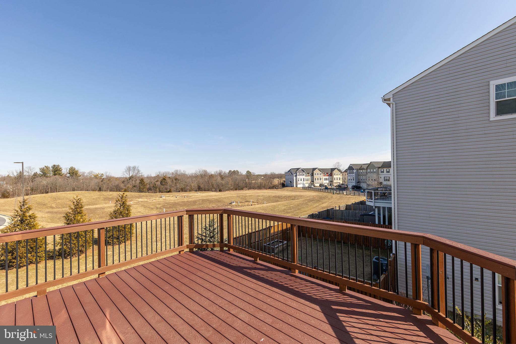 210 Flyfoot Drive Stephenson, VA 22656 - Photo 23 of 38 a view of a balcony with wooden floor and lake view