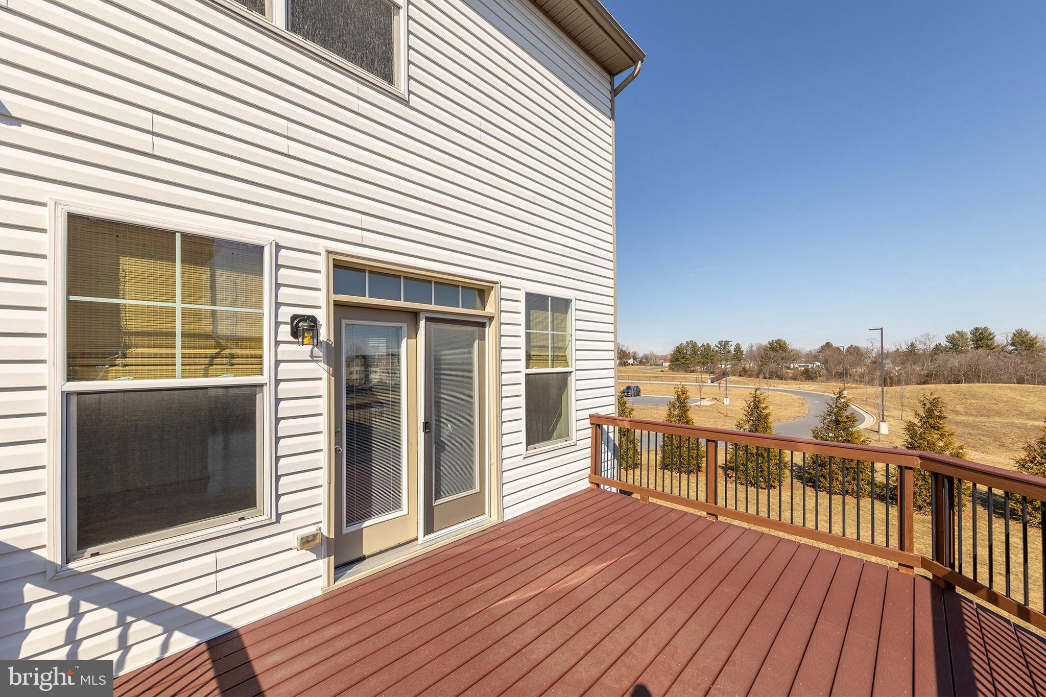 210 Flyfoot Drive Stephenson, VA 22656 - Photo 24 of 38 a view of a balcony with wooden floor and floor to ceiling window