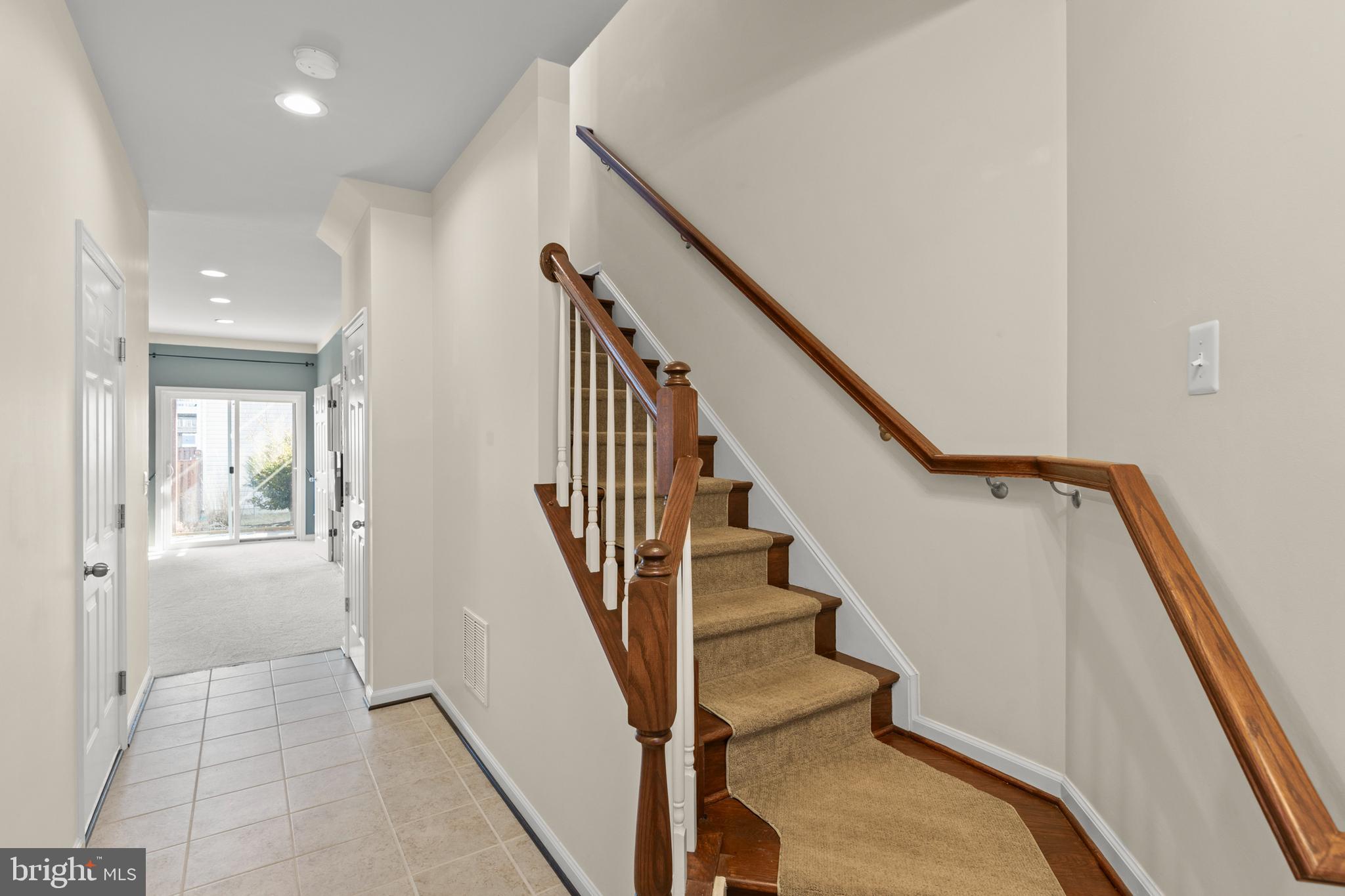 210 Flyfoot Drive Stephenson, VA 22656 - Photo 4 of 38 a view of staircase with lots of frames on wall and windows