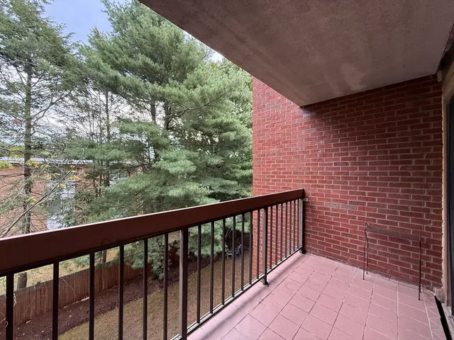 a view of a balcony with wooden fence
