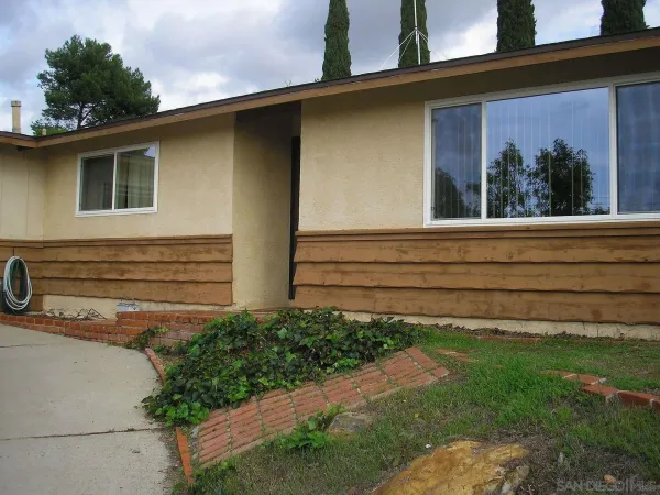 a view of house with backyard