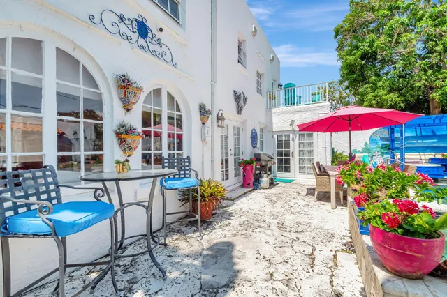 a view of a house with backyard porch and furniture